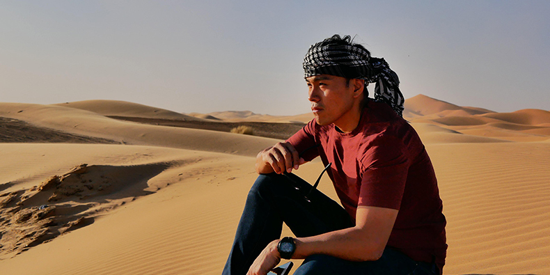 man sitting on the sand